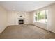 Bright living room boasts a charming fireplace and large window offering plenty of natural light at 4860 W 125Th Ave, Broomfield, CO 80020