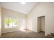Bright living room featuring vaulted ceilings, a large window, and neutral carpet flooring at 4860 W 125Th Ave, Broomfield, CO 80020
