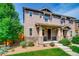 Two-story townhome with front porch and landscaping at 1567 S Dallas Cir, Denver, CO 80247