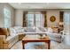 Living room with L-shaped sectional sofa and coffee table at 1567 S Dallas Cir, Denver, CO 80247