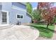 Charming backyard with a concrete patio, grill, and a vibrant red maple tree at 14214 Lakeview Ln, Broomfield, CO 80023