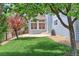 Lush backyard featuring a stone patio area and meticulous landscaping details at 14214 Lakeview Ln, Broomfield, CO 80023
