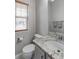 Stylish half bathroom featuring a granite countertop and sleek fixtures, plus a window at 14214 Lakeview Ln, Broomfield, CO 80023