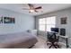 Comfortable bedroom with a ceiling fan, desk, and charming artwork displayed at 14214 Lakeview Ln, Broomfield, CO 80023