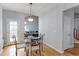 Dining area with hardwood floors, modern lighting, and view into the living room at 14214 Lakeview Ln, Broomfield, CO 80023