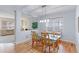 Open-concept dining area featuring hardwood floors, modern light fixture, and adjacent living space at 14214 Lakeview Ln, Broomfield, CO 80023