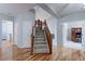 Welcoming foyer with hardwood floors, a staircase, and access to the home office through French doors at 14214 Lakeview Ln, Broomfield, CO 80023