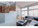 Bright living room featuring a high ceiling, large windows, and a comfortable gray sofa at 14214 Lakeview Ln, Broomfield, CO 80023
