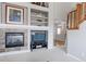 Cozy living room with fireplace, built-in shelves, and view to staircase at 14214 Lakeview Ln, Broomfield, CO 80023