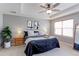 Relaxing main bedroom featuring a tray ceiling, ceiling fan, and a large window at 14214 Lakeview Ln, Broomfield, CO 80023