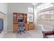 Bright office features a built-in desk and shelving, as well as a fireplace at 14214 Lakeview Ln, Broomfield, CO 80023