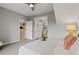 This bedroom features a contemporary ceiling fan, bed, and access to the Primary bath at 18601 E Water Dr # A, Aurora, CO 80013