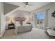 Spacious bedroom with a ceiling fan, bedside lamps, and sliding glass doors to a patio at 18601 E Water Dr # A, Aurora, CO 80013