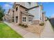 Charming exterior view of a townhome with stone and siding, complemented by rock landscaping at 18601 E Water Dr # A, Aurora, CO 80013