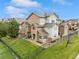 Beautiful multi-story townhouse boasting stone and siding exterior, set on a well-maintained lawn with dark metal fencing at 18601 E Water Dr # A, Aurora, CO 80013