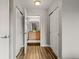 Hallway with wood floors leading to the Primary bathroom at 18601 E Water Dr # A, Aurora, CO 80013