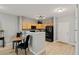 Well-lit kitchen showcases wood cabinets, dark appliances, and an adjacent dining area creating a functional and inviting space at 18601 E Water Dr # A, Aurora, CO 80013