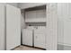 Bright laundry room featuring a washer, a dryer and storage cabinets at 18601 E Water Dr # A, Aurora, CO 80013