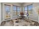 Inviting home office with a glass desk, leather chair, and natural light from large windows at 18601 E Water Dr # A, Aurora, CO 80013