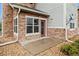 Cozy outdoor patio area with stone accents and a red door entrance at 18601 E Water Dr # A, Aurora, CO 80013