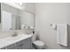 Clean bathroom featuring a gray vanity, white sink, and a large framed mirror at 9636 W Chatfield Ave # C, Littleton, CO 80128