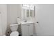 Bathroom with white vanity, toilet, and mirror at 9636 W Chatfield Ave # C, Littleton, CO 80128