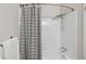 Clean bathroom featuring a shower with white tile and modern fixtures at 9636 W Chatfield Ave # C, Littleton, CO 80128