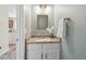 Powder room featuring a granite countertop and stylish mirror at 9636 W Chatfield Ave # C, Littleton, CO 80128