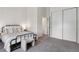 Spacious bedroom with a cozy bed, a large closet, and soft carpet flooring at 9636 W Chatfield Ave # C, Littleton, CO 80128