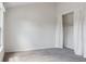 Bright bedroom featuring neutral paint, white trim, and a closet with curtains at 9636 W Chatfield Ave # C, Littleton, CO 80128
