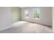 Bright bedroom featuring neutral paint, two large windows, and soft carpeting at 9636 W Chatfield Ave # C, Littleton, CO 80128
