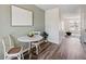 Bright dining area with a round table, two chairs, and artwork on the wall at 9636 W Chatfield Ave # C, Littleton, CO 80128