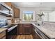 Modern kitchen with stainless steel appliances, granite countertops, and ample natural light at 9636 W Chatfield Ave # C, Littleton, CO 80128