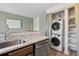 Laundry area with stacked washer and dryer and extra storage at 9636 W Chatfield Ave # C, Littleton, CO 80128