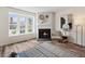 Cozy living room featuring a fireplace, large window, and modern decor at 9636 W Chatfield Ave # C, Littleton, CO 80128