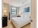Bright bedroom with large windows, neutral walls, and elegant furnishings at 444 17Th St # 701, Denver, CO 80202