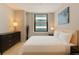 Cozy bedroom with a large window and minimalist design at 444 17Th St # 701, Denver, CO 80202