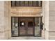 Exterior front entrance to building with glass doors and stone facade at 444 17Th St # 701, Denver, CO 80202