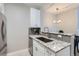 Beautiful kitchen with granite counters, stainless steel appliances, and breakfast bar at 444 17Th St # 701, Denver, CO 80202