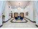 Elegant lobby area with white walls, marble flooring, and blue seating beneath a chandelier at 444 17Th St # 701, Denver, CO 80202