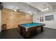 Game room with a pool table and wood-paneled accent wall at 7877 E Mississippi Ave # 202, Denver, CO 80247