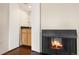 Convenient wet bar with wood cabinets and a fireplace at 7877 E Mississippi Ave # 202, Denver, CO 80247