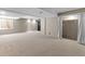 Open basement area with carpet, light neutral paint, and lots of empty space at 2181 E Phillips Ln, Centennial, CO 80122