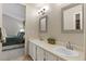 Bright bathroom with dual vanities, and a connecting view to the main bedroom at 2181 E Phillips Ln, Centennial, CO 80122