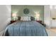 Cozy bedroom with hardwood floors, decorative accent wall, and neutral decor at 2181 E Phillips Ln, Centennial, CO 80122
