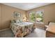 Bedroom with a view to green lush trees, neutral carpet, and bedside lamp at 2181 E Phillips Ln, Centennial, CO 80122