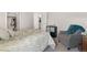 Bedroom with neutral-toned carpet, closet and ensuite bathroom with a relaxing gray chair at 2181 E Phillips Ln, Centennial, CO 80122