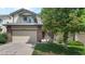 Charming two-story townhouse featuring a well-maintained lawn and attached garage at 2181 E Phillips Ln, Centennial, CO 80122