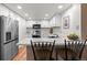 Bright kitchen with stainless steel appliances, white cabinets, and breakfast bar at 2181 E Phillips Ln, Centennial, CO 80122