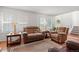 Bright living room with natural light, comfortable seating, and staircase access at 2181 E Phillips Ln, Centennial, CO 80122